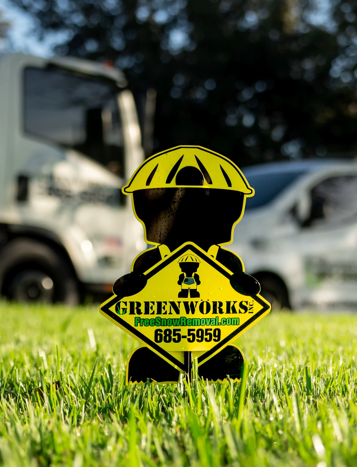Greenworks signage in a grass